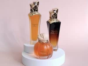 Collection of Maison Asrar perfume bottles on a white base and pink background